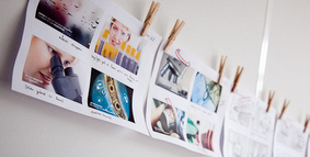 Printed or drawn storyboards hanging in a row.