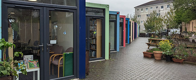 A row of colourful shipping containers.