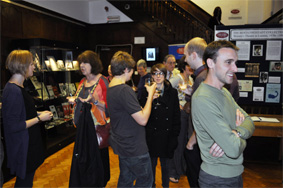 Several people socialising in Theatre Collection exhibition