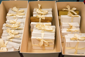 Three open boxes of wrapped archive items tied with archival tape