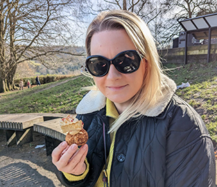 person wearing sunglasses holding food