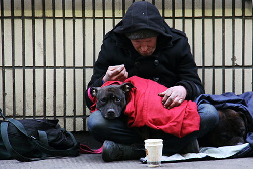 Homeless man with his dog on a London street